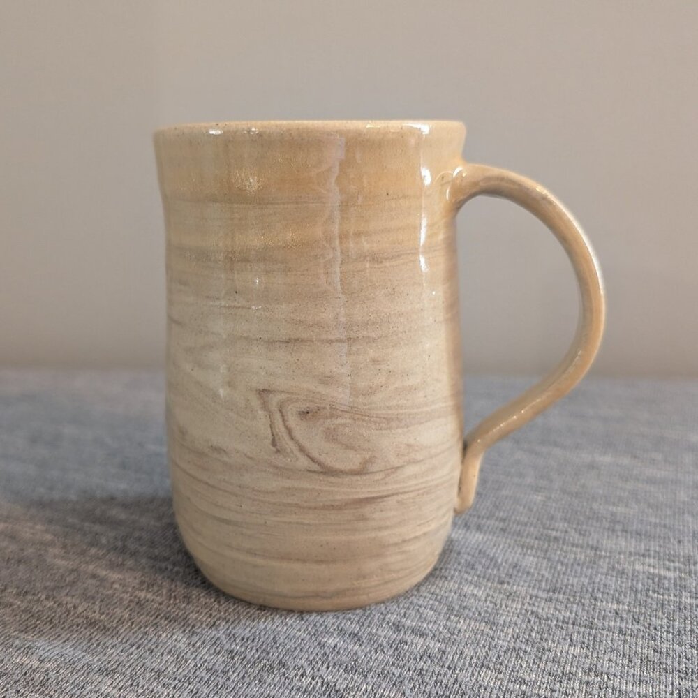 Handmade Beige Pottery Mug with Swirl Glaze, Signed "Tathlina Lovlin"
